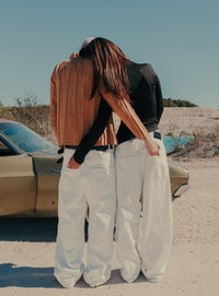 Pleated White Jeans — back view, two models at a chalk quarry — Confession Road campaign