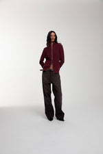 Engineered Zip Cardigan in Oxblood and Trace Cut Denim Jeans in Chocolate Brown worn by female model