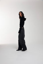 Frame Knitted Hoodie in Black worn by female model
