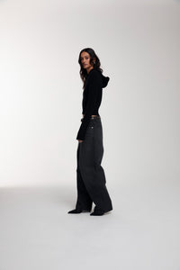 Frame Knitted Hoodie in Black worn by female model