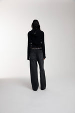Frame Knitted Hoodie in Black worn by female model